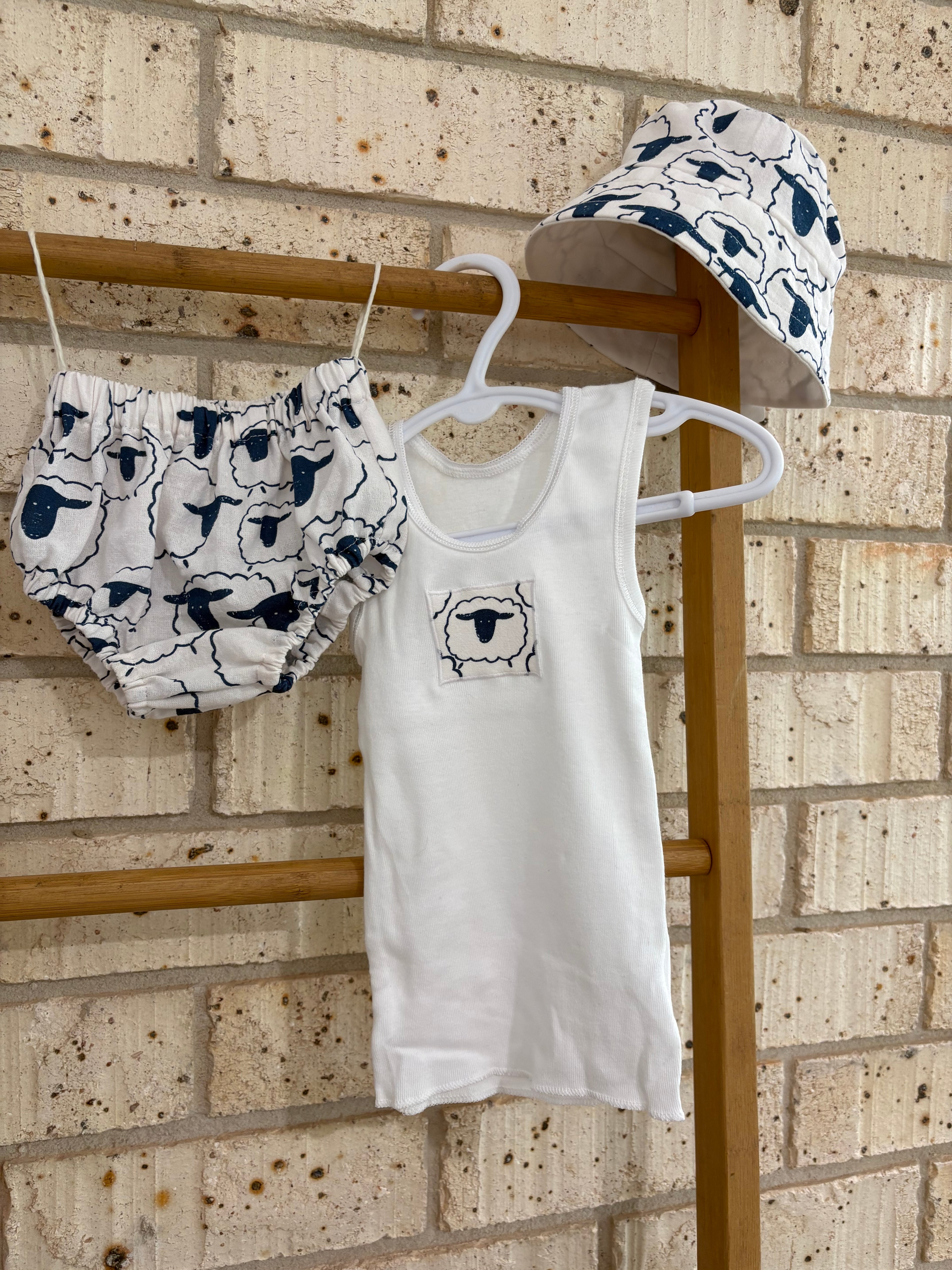 Singlet, nappy pants and bucket hat sheep